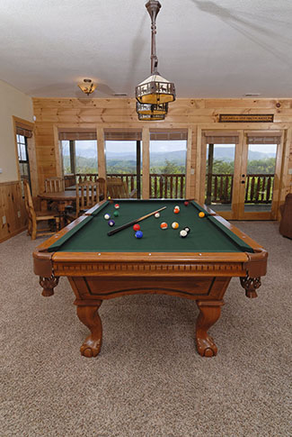 Four Bedroom Cabin with a lower level gameroom and bar area that has a pool table overlooking a mountain view